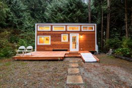 Small wooden cabin house in the evening. Exterior design.