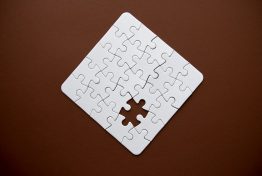 connected-blank-puzzle-pieces-isolated-on-a-brown_t20_noYgo8