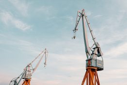 vecteezy_construction-cranes-under-blue-sky_1224479